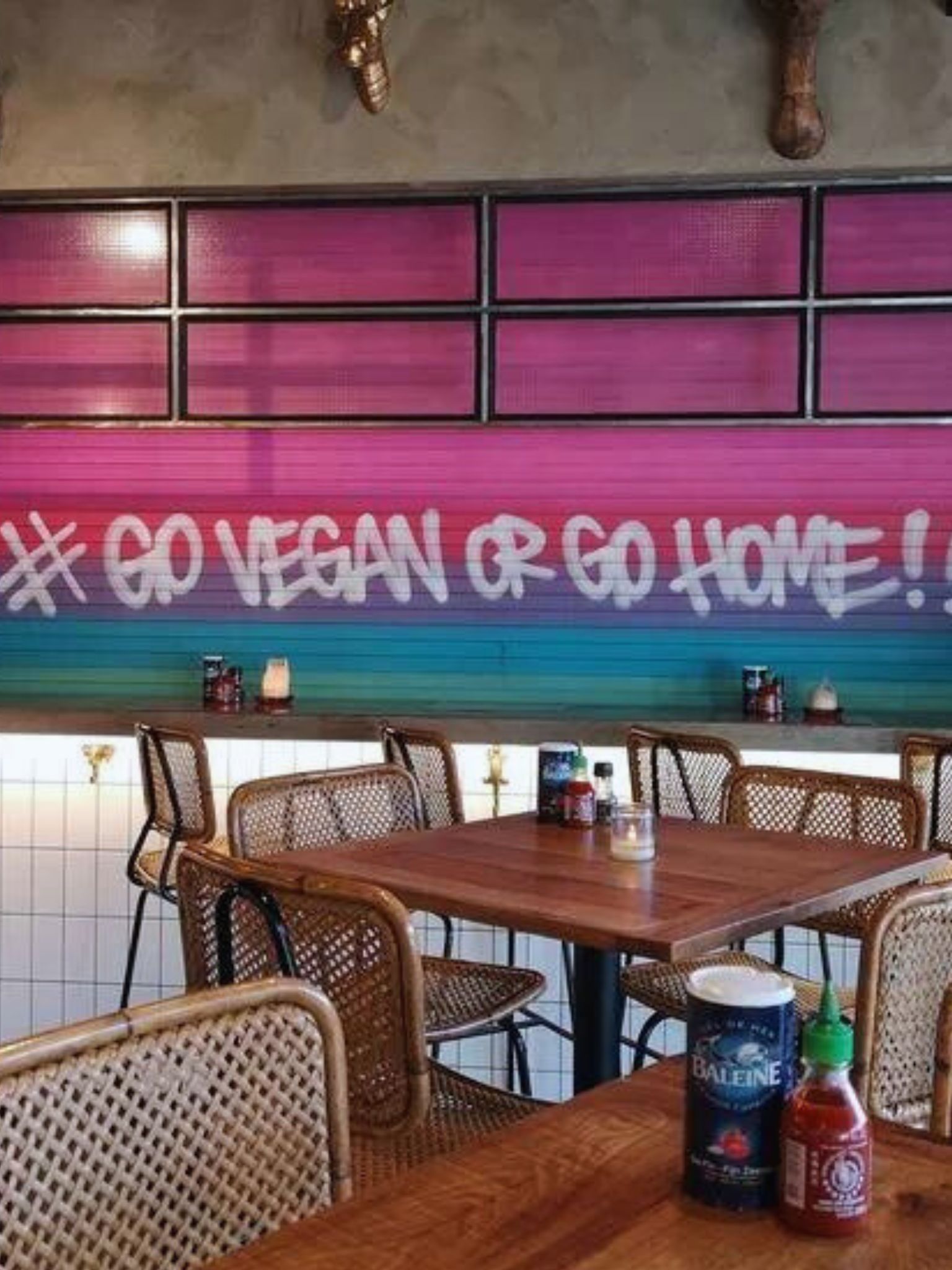 A sign in a restaurant stating Go vegan or Go home