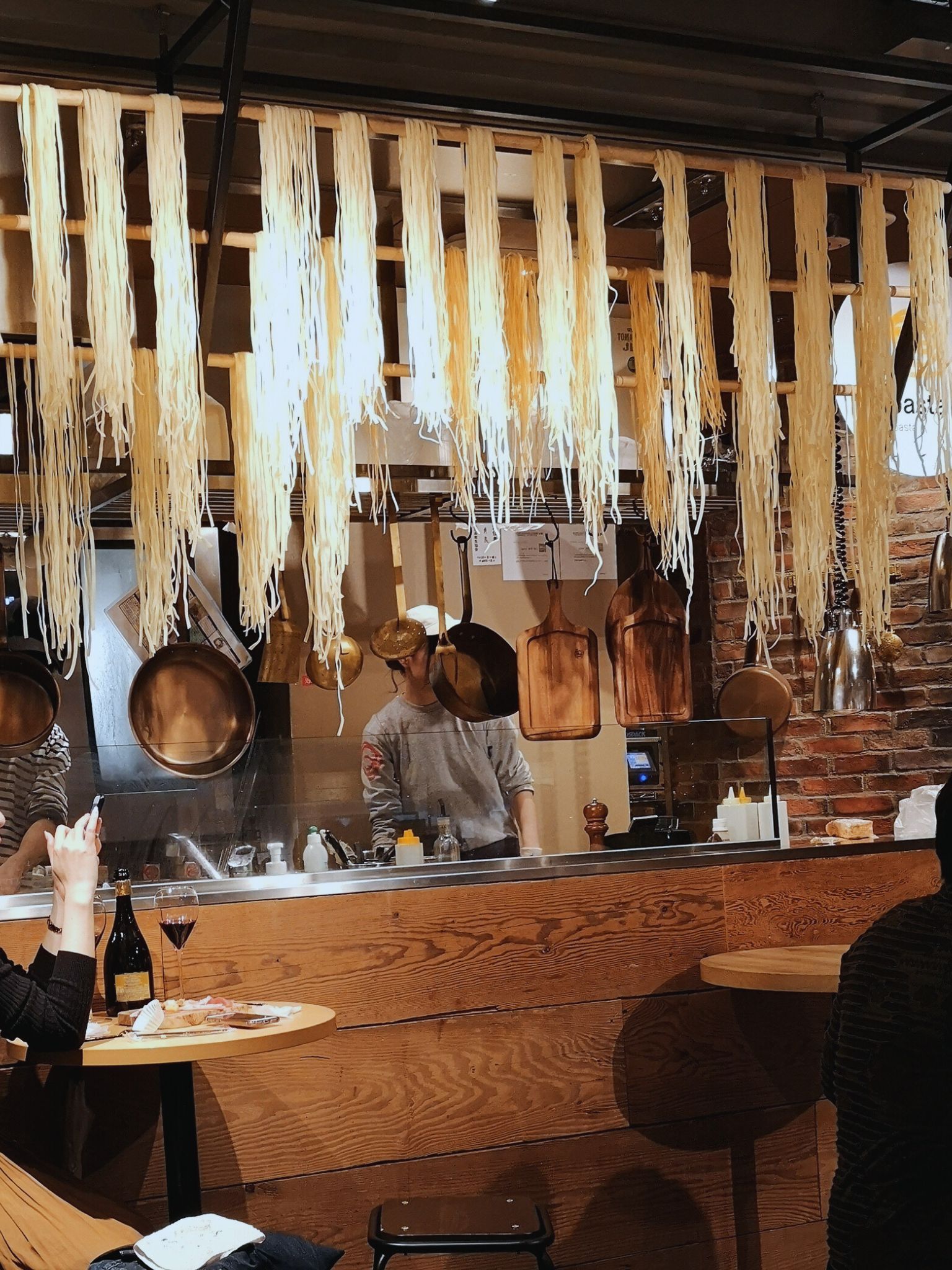 A Japanese restaurant with noodles hanging near the kitchen